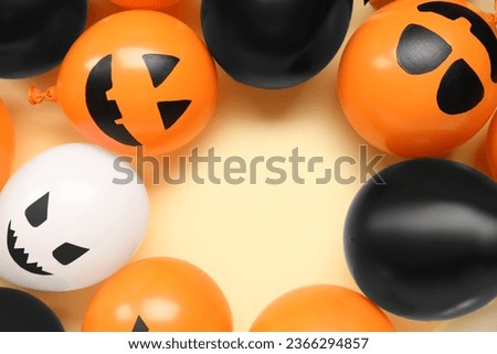 Frame made of different funny Halloween balloons on yellow background