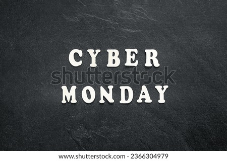 Cyber Monday text on a black background, top view.