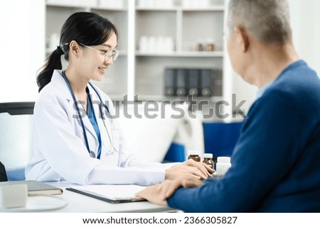 Female doctor consulting senior old patient filling form at consultation, talking to senior old patient filling signing medical paper at appointment visit in clinic.	