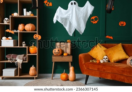 Interior of living room decorated for Halloween with sofa and pumpkins Royalty-Free Stock Photo #2366307145