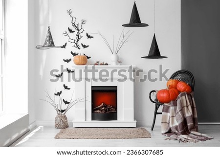 Interior of living room decorated for Halloween with fireplace and paper bats