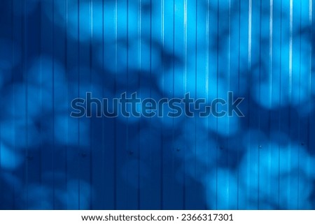 Background and texture of corrugated metal sheet of blue color with the effect of shadows from wood Royalty-Free Stock Photo #2366317301