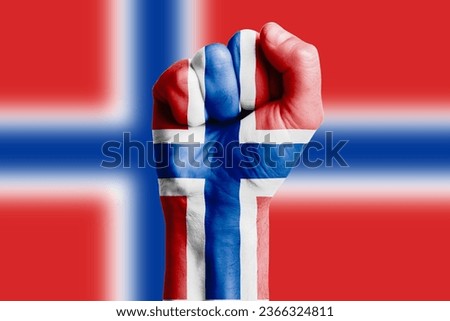 Man hand fist of NORWAY flag painted. Close-up Royalty-Free Stock Photo #2366324811