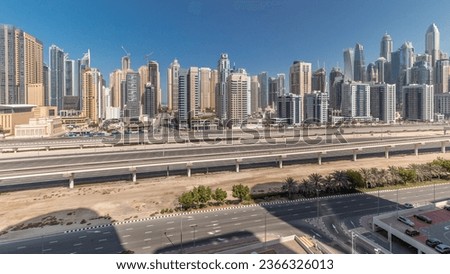 Panorama showing Dubai Marina skyscrapers and Sheikh Zayed road with metro railway aerial. Traffic on a highway near modern towers, United Arab Emirates Royalty-Free Stock Photo #2366326013