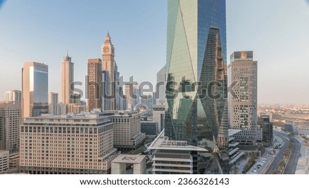 Dubai International Financial district aerial during all day with shadows moving fast. Panoramic view of business and financial office towers. Skyscrapers with hotels and shopping malls near downtown Royalty-Free Stock Photo #2366326143