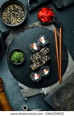 Sushi roll with tuna, salmon and cheese. Asian cuisine. Close up. Free space for your text.