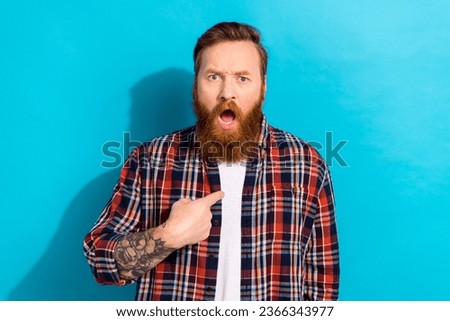 Photo of offended crazy annoyed man with stylish beard dressed checkered shirt directing at himself isolated on blue color background Royalty-Free Stock Photo #2366343977