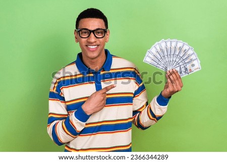 Photo of young businessman directing finger financial results extra bonus money for best workers isolated on green color background