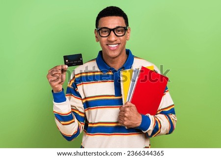 Photo of young man black bank worldwide debit card options advert buy college tools bright documents isolated on green color background
