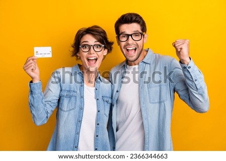 Photo of two business people hold credit card raise fist up enjoy deposit income profit isolated shine color background