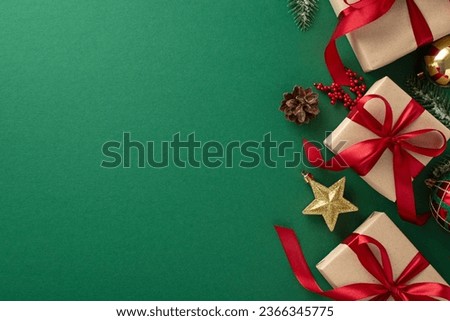 Festive holiday wishes. Top view of gift packages tied with red bows, chic Christmas decor, gilded ornaments, cone, mistletoe, frosty pine branches on green surface, ideal for greetings or advertising