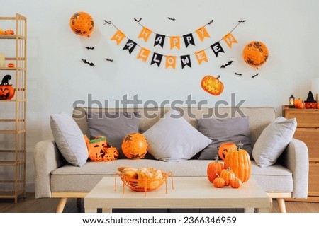 Halloween theme decorated living room. Lifestyle Halloween season family house interior. Traditional Halloween decorations background.