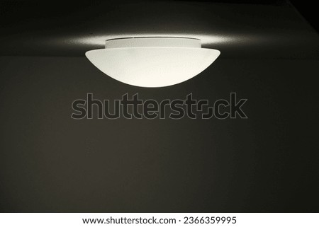 modern round ceiling lamp with white light in the hallway Royalty-Free Stock Photo #2366359995