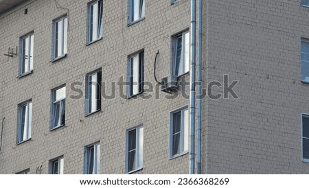 the facade of a white brick multi-storey house with windows