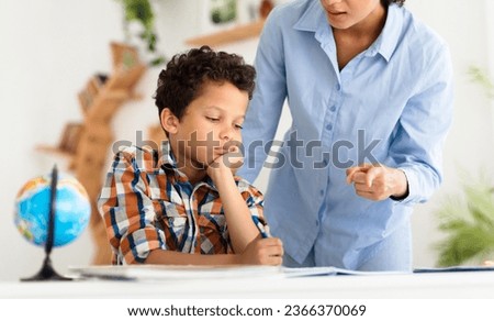 Strict School Teacher Woman Scolding Unhappy Little Schoolboy For Bad Behavior At Class Or Badly Done Homework At Classroom Indoors. Kid Education Issues Concept. Cropped Shot Royalty-Free Stock Photo #2366370069