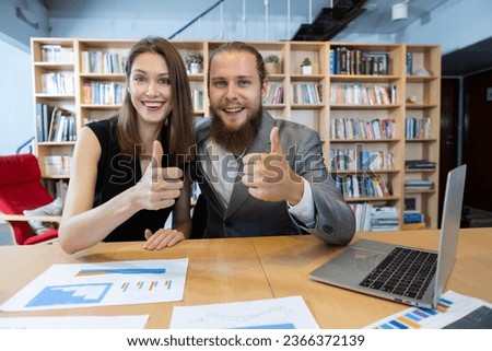 Two businesspeople looking at camera and thumb up with laptop. Teamwork planning make branding. strategy marketing of company. woman manager and creative man meeting for work in office.