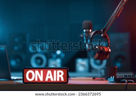 Radio broadcasting station professional equipment and On Air light sign in the foreground
