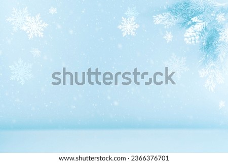 Winter  blurred background with silhouette of fir tree, pine cones and snowflakes. Abstract Winter scene.