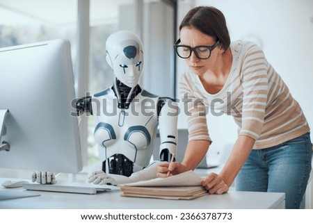 Woman and AI robot working together in the office, automation and technology concept Royalty-Free Stock Photo #2366378773