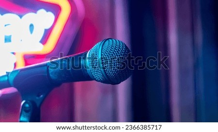 Microphone on the background of neon light close up