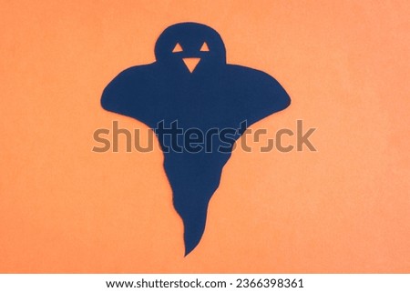 Happy Halloween, Ghost smile make from black paper cut on orange background, Decorative Halloween concept