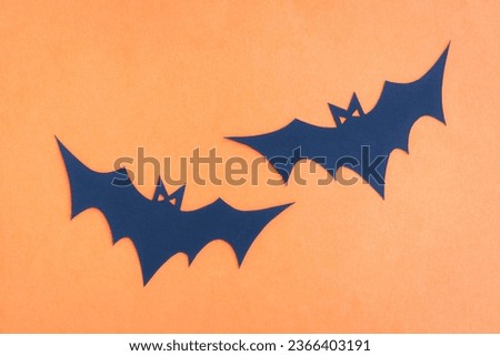 Happy Halloween, Bat flying make from paper cut on orange background, Decorative Halloween concept	