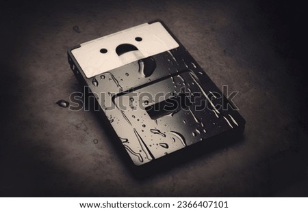 Sad cartoony floppy disk like object crying big tears of sadness