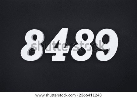 Black for the background. The number 8489 is made of white painted wood.