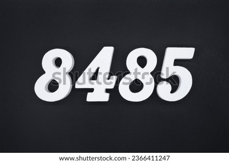 Black for the background. The number 8485 is made of white painted wood.