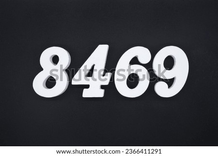 Black for the background. The number 8469 is made of white painted wood.