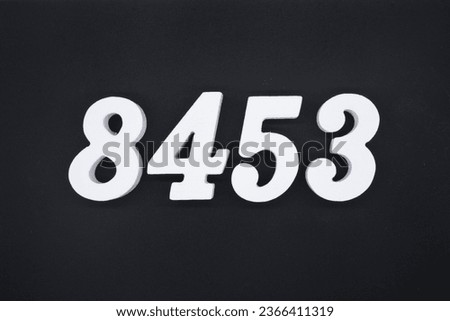 Black for the background. The number 8453 is made of white painted wood.