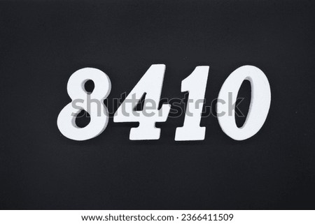 Black for the background. The number 8410 is made of white painted wood.