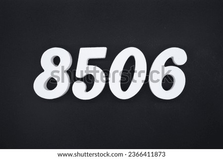 Black for the background. The number 8506 is made of white painted wood.