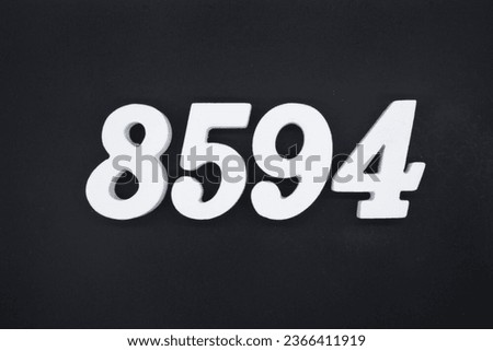 Black for the background. The number 8594 is made of white painted wood.