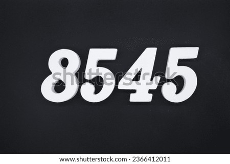 Black for the background. The number 8545 is made of white painted wood.