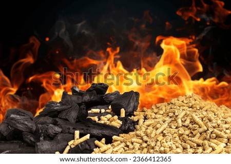 wood pellets and pieces of coal with flames in the background