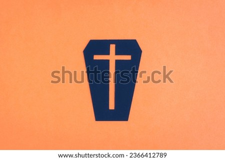 Happy Halloween, Black coffin with Christian cross make from paper cut on orange background, Decorative Halloween concept