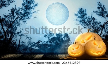 Jack-o-Lantern in the wooden floor with the misty forest with a full moon background. Halloween Wallpaper concept