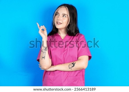 Photo of attractive young beautiful doctor woman direct finger empty space cheap dentistry