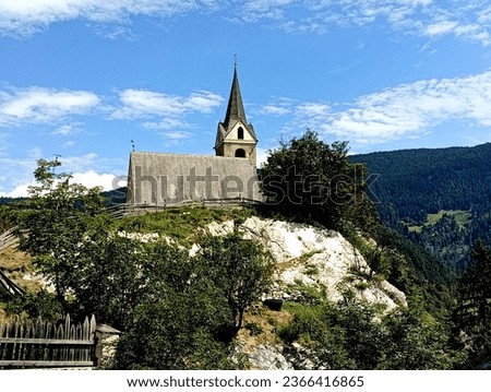 In the small town of Rodengo, in Val Pusteria, there is the ancient church of Santa Maria Assunta dating back to the 12th century, located on a rocky spur in a bucolic context Royalty-Free Stock Photo #2366416865