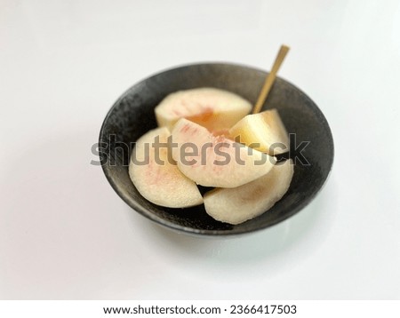 white peaches placed in a white space