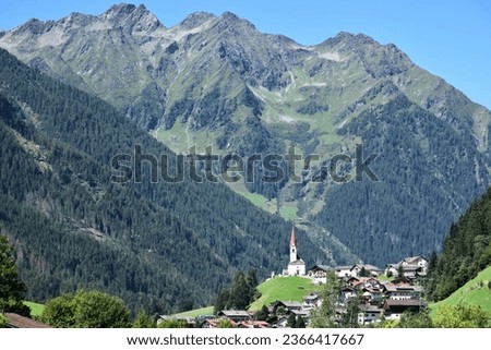 In a side valley of the Aurina valley, Selva dei Molini, the tiny village of Muhlwald stand out against the backdrop of the Monte Gruppo massif Royalty-Free Stock Photo #2366417667
