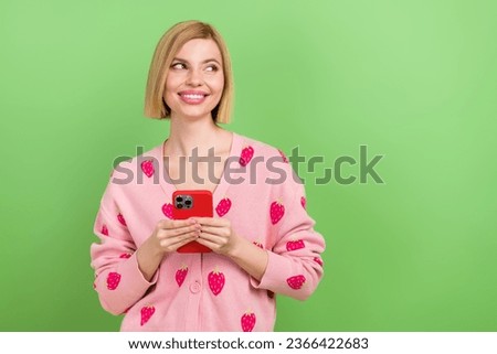Photo of young blogging woman red case iphone device watching facebook stats reviews empty space isolated on green color background