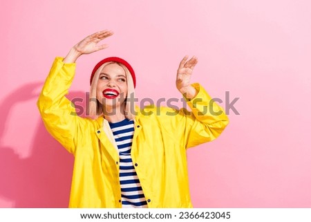 Photo of pretty nice lovely girl wear yellow stylish bright waterproof outfit look up empty space isolated on pink color background
