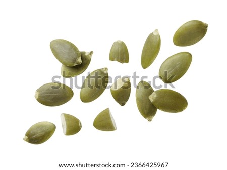 Pumpkin seeds flying close-up on a white background. Isolated Royalty-Free Stock Photo #2366425967