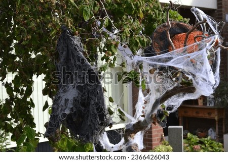 Halloween tree with witches hats and spiderwebs