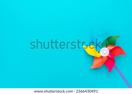 Pinwheel on turquoise blue background with copy space.