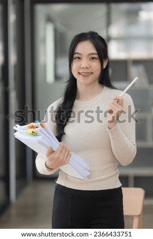 Asian businesswoman working with document papers at work in office, Checking financial papers.