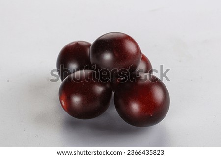 Raw ripe black kumato cherry tomato