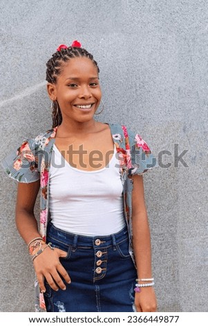 Close-up portrait of beautiful young black girl smiling outdoors
